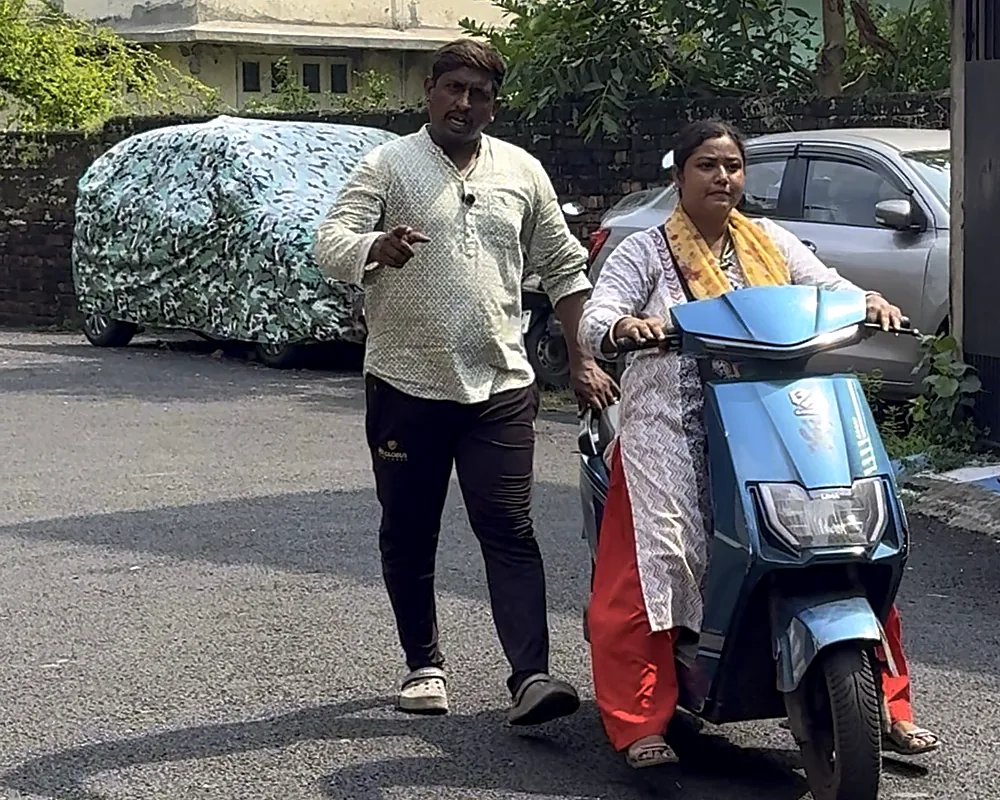 Trainer walking beside a learner on a quiet residential lane