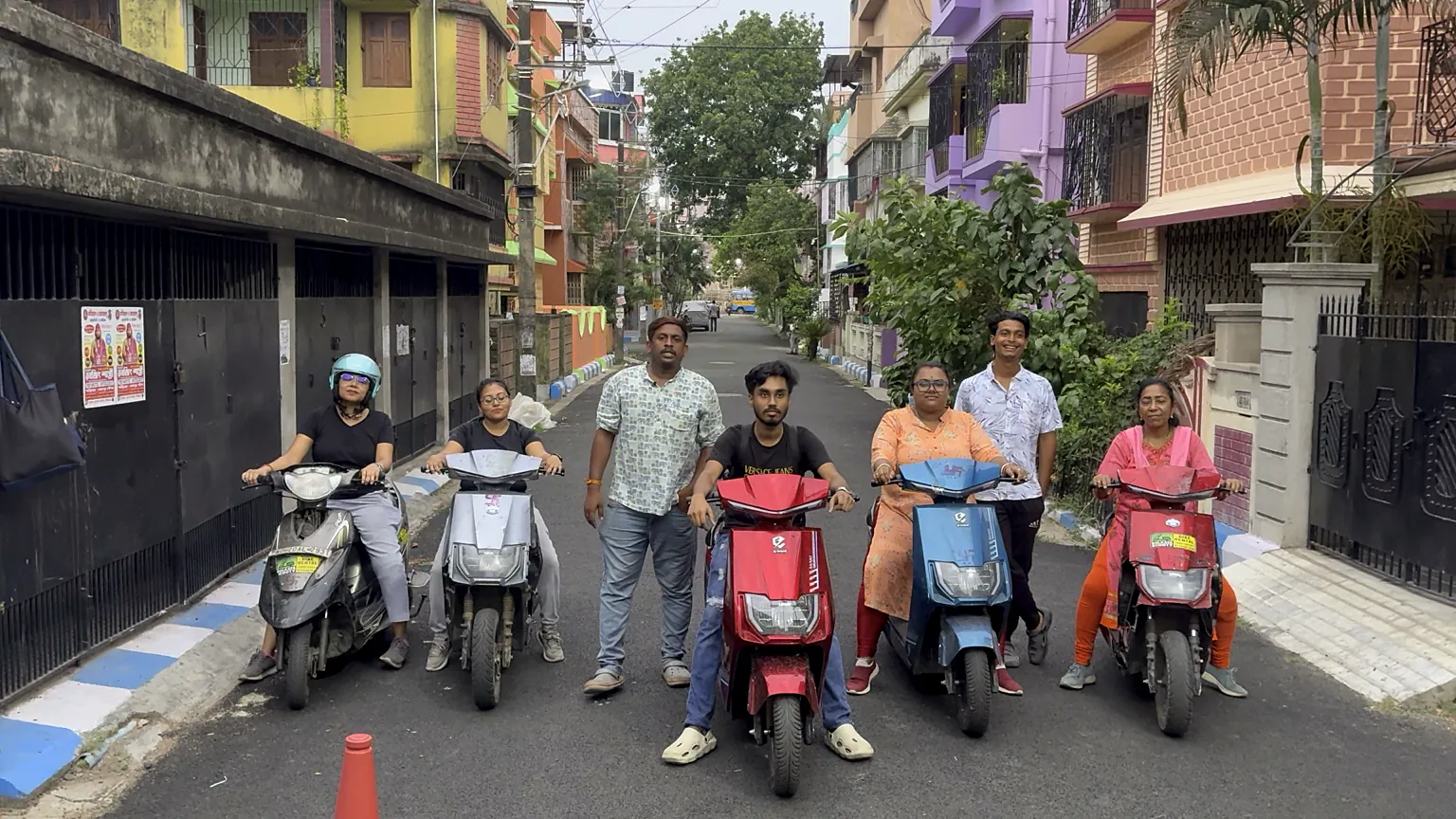 Zero Fear learners on their scooties with their trainers in a Kolkata lane