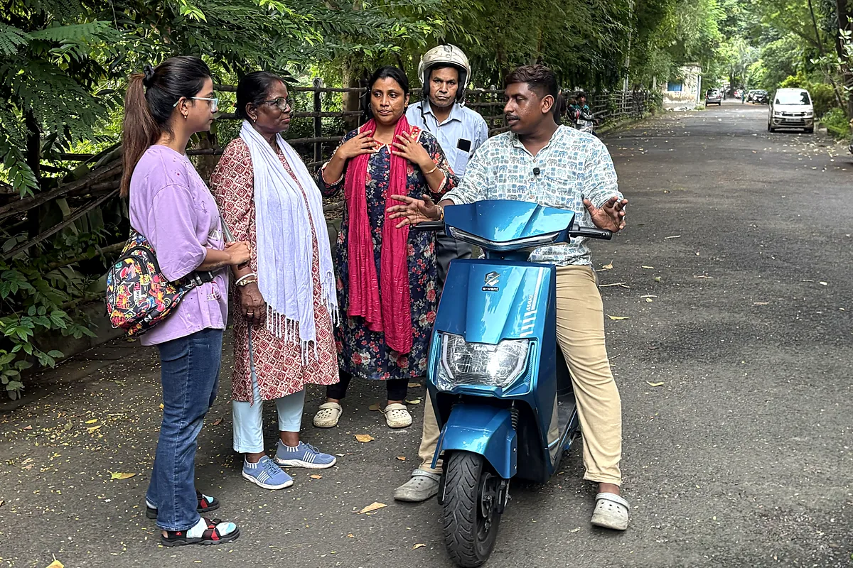 Trainer explaining scooty controls to new learners before the first ride